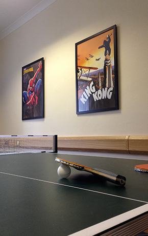 ping pong table with movie posters on the walls