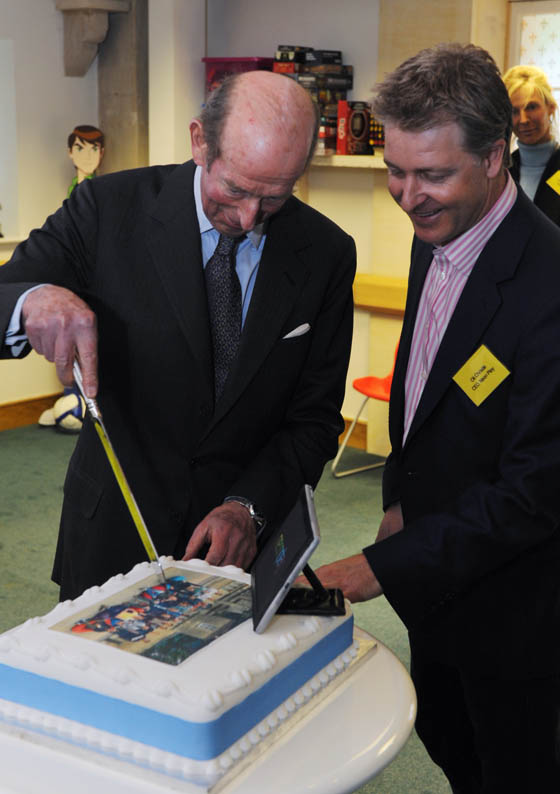 Duke of Kent cuts the cake with Neon Play's CEO Oli Christie 